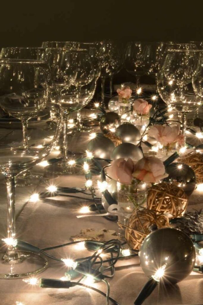Dinner table adorned with glistening fairy lights